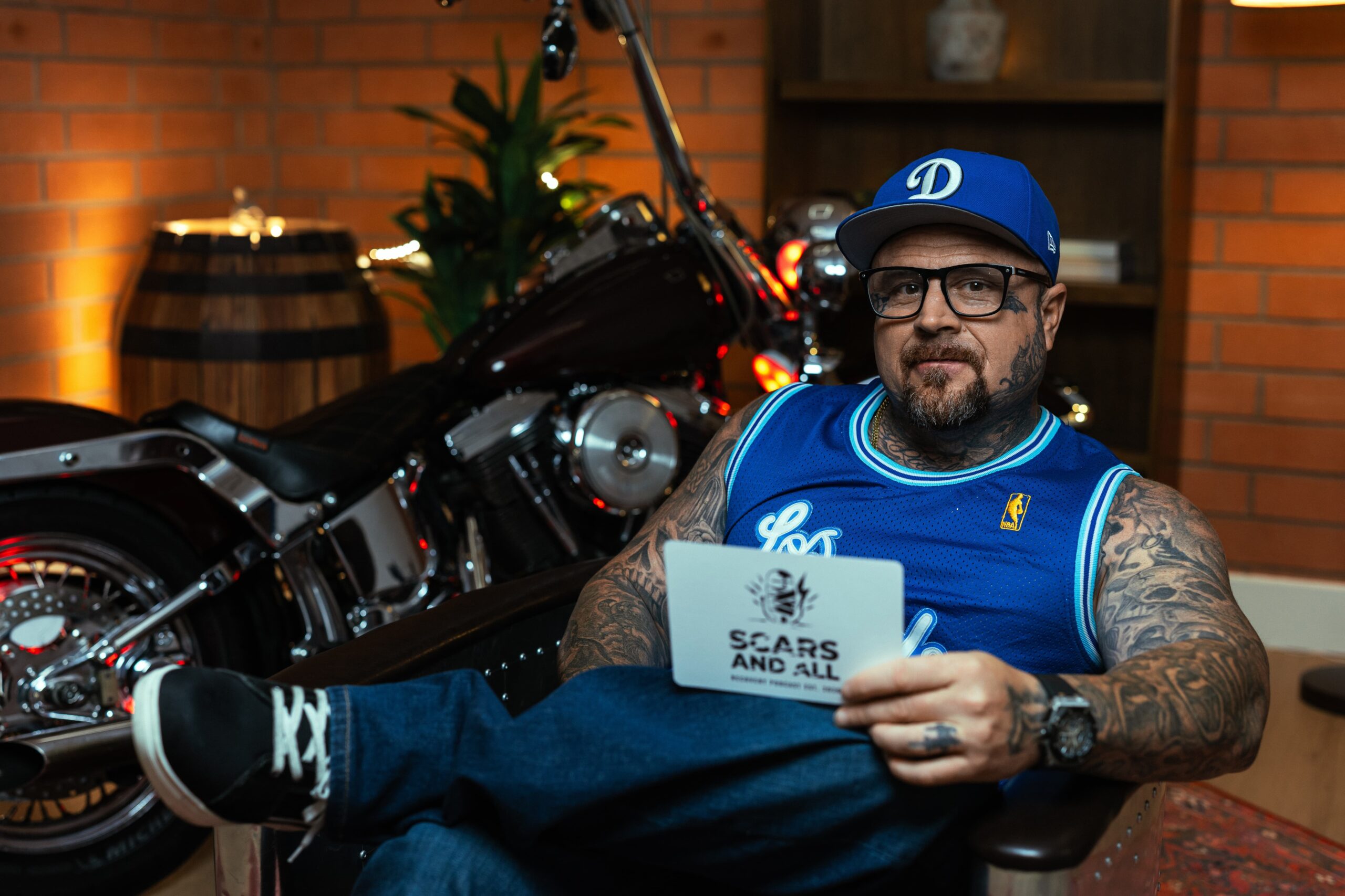 Frank Wills of Scars and All holding the podcast sign
